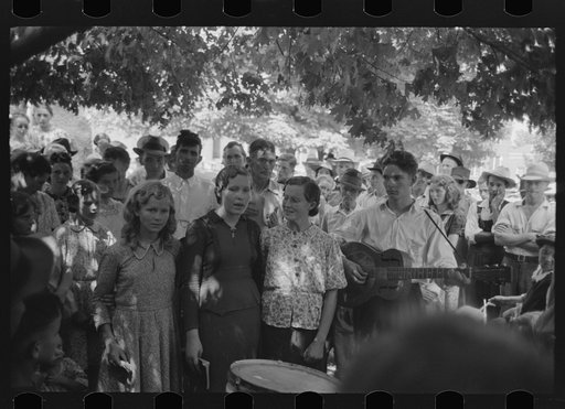 Revivalist singing at rally under trees in square, Saturday afternoon, Tahlequah, Oklahoma