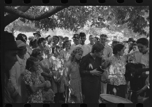 Revivalist surrounded by speculators at rally under trees in square, Saturday afternoon, Tahlequah, Oklahoma