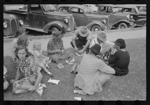 Farm people eating watermelon on lawn in front of courthouse, Tahlequah, Oklahoma