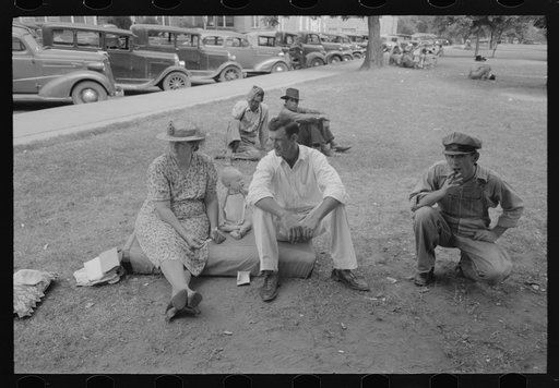 Farm people sitting on automobile cushion in square, Tahlequah, Oklahoma
