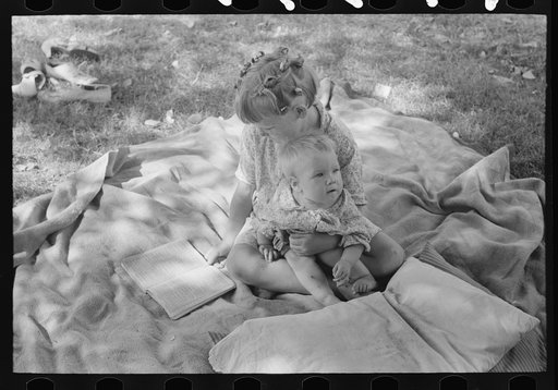 Little girl and her baby brother reading Bible, community camp, Oklahoma City, Oklahoma