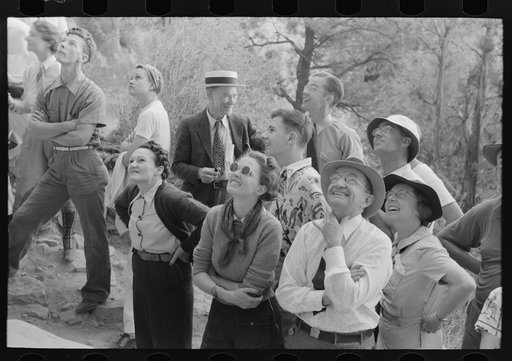 Tourists looking for Indian hieroglyphic pointed out by ranger, Mesa Verde National Park, Colorado