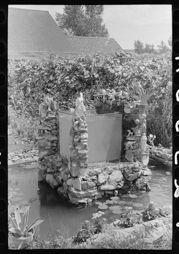 Fountain and goldfish tank in garden of Italian merchant in Cimarron, New Mexico