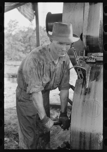 Untitled photo, possibly related to: Examining mud from bottom of hole to determine characterisitcs of stratum through which they are drilling oil. Near Saint Louis, Oklahoma