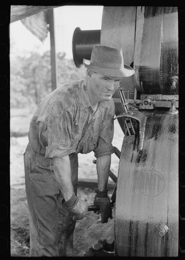 Examining mud from bottom of hole to determine characterisitcs of stratum through which they are drilling oil. Near Saint Louis, Oklahoma