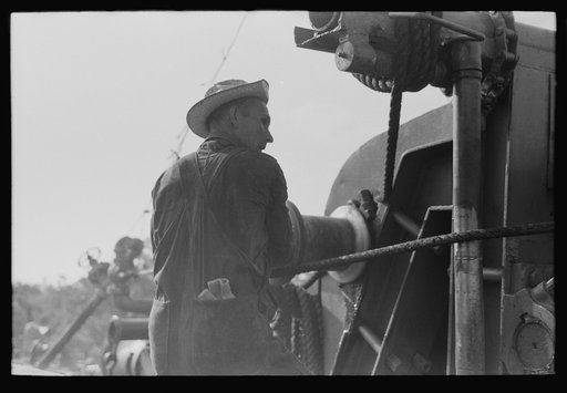 Untitled photo, possibly related to: Roughnecks working on engine, Seminole oil field, Oklahoma
