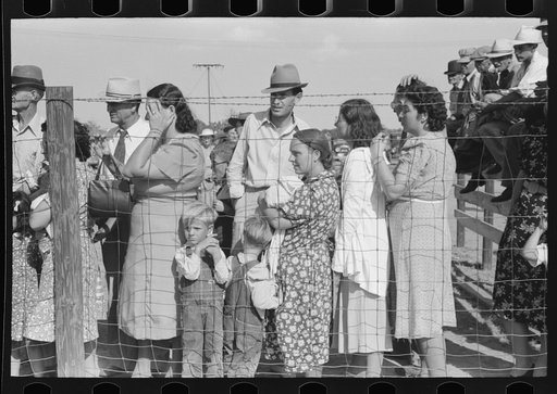 Spectators behind the fence at 4-H Club fair, Cimarron, Kansas