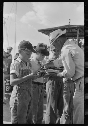 Distributing pie to contestants in pie eating contest, 4-H Club fair, Cimarron, Kansas