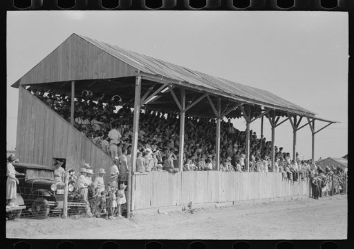 The grandstand at former county fairgrounds filled with spectators at the 4-H Club fair, Cimarron, Kansas