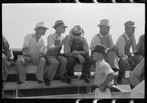 Farmers sitting on the fence at 4-H Club fair, Cimarron, Kansas