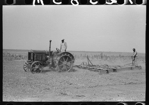 Tractor-drawn floater on Gray County farm, Kansas