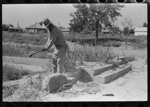 Untitled photo, possibly related to: Wrecking foundation of old building in Forgan, Oklahoma, which is a ghost dust town