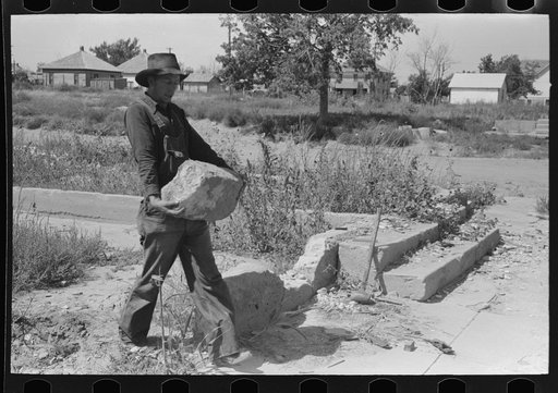 Untitled photo, possibly related to: Wrecking foundation of old building in Forgan, Oklahoma, which is a ghost dust town