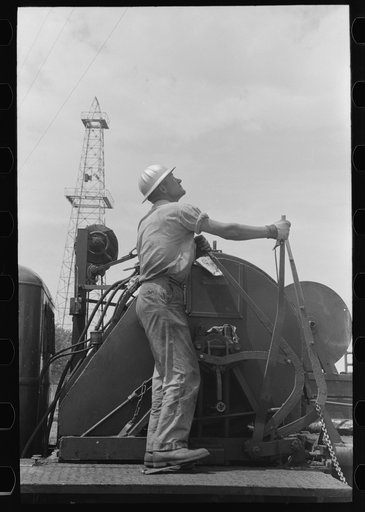Untitled photo, possibly related to: Winch operator at oil well in Oklahoma City, Oklahoma