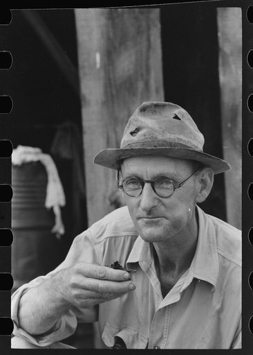 Untitled photo, possibly related to: Roustabout taking chew of tobacco, Seminole oil field, Oklahoma
