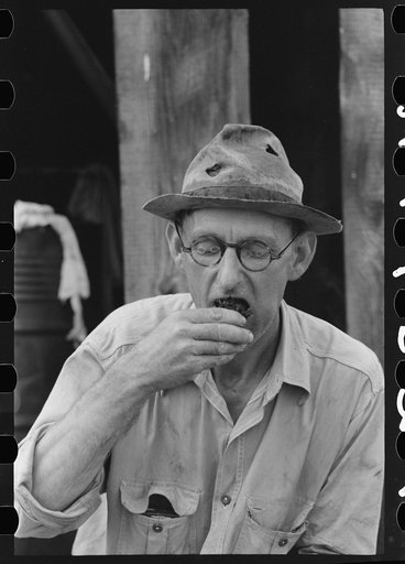 Untitled photo, possibly related to: Roustabout taking chew of tobacco, Seminole oil field, Oklahoma