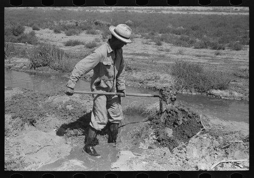 Untitled photo, possibly related to: Mr. Johnson, FSA (Farm Security Administration) client with part interest in cooperative well, irrigating his fields near Syracuse, Kansas
