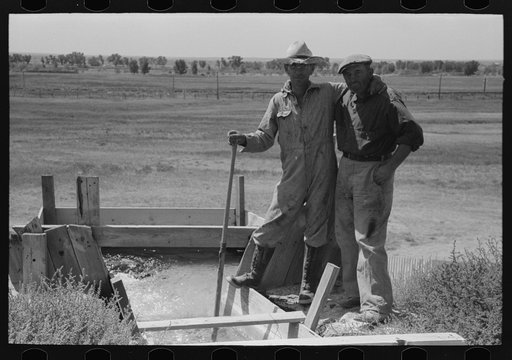 Untitled photo, possibly related to: Cooperation in irrigation well. Mr. Johnson and Mr. Wright, FSA (Farm Security Administration) clients, Syracuse, Kansas