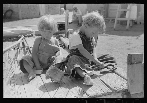 Children of Spanish-American farm family playing on wagon, Taos County, New Mexico