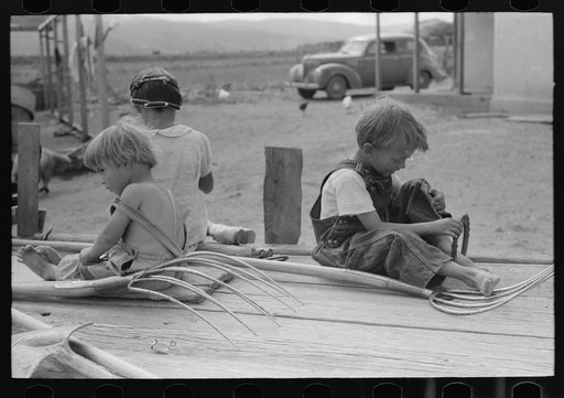 Untitled photo, possibly related to: Children of Spanish-American farm family playing on wagon, Taos County, New Mexico