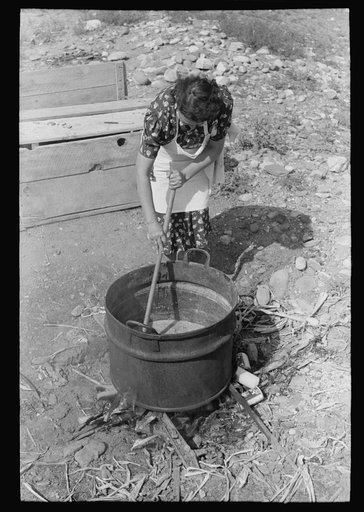 Spanish-American FSA (Farm Security Administration) client stirring kettle of soap, Taos County, New Mexico