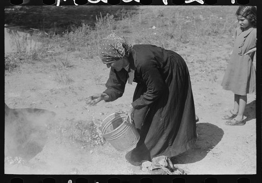 Sprinkling hot coals with water, Taos County, New Mexico