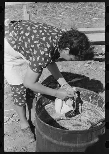 Untitled photo, possibly related to: Spanish-American FSA (Farm Security Administration) client wiping homemade soap to remove surface dirt, Taos County, New Mexico