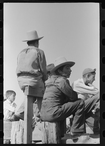 Spanish-American family waiting at the gate at Bean Day rodeo, Wagon Mound, New Mexico
