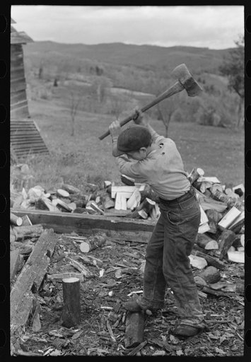 Splitting wood, getting ready for the winter, on farm near Bradford, Vermont