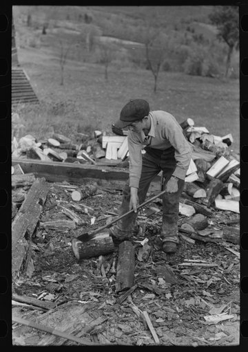 Splitting wood, getting ready for the winter, on farm near Bradford, Vermont