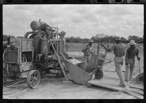 Untitled photo, possibly related to: Pouring concrete at migrant camp under construction at Sinton, Texas