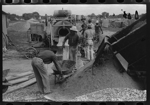 Untitled photo, possibly related to: Activity around concrete mixer at migrant camp under construction at Sinton, Texas