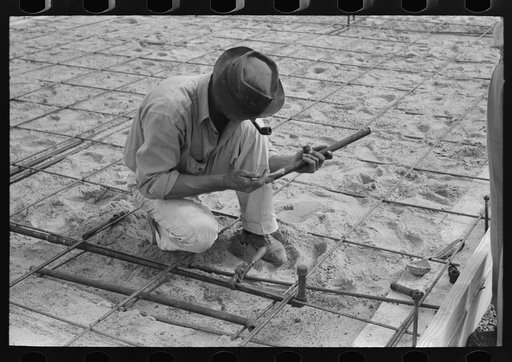 Untitled photo, possibly related to: Fitting water pipe at migrant camp under construction at Sinton, Texas