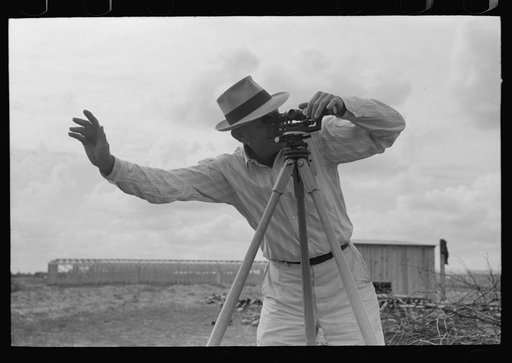 Untitled photo, possibly related to: Smoothing concrete floor at migrant camp under construction at Sinton, Texas
