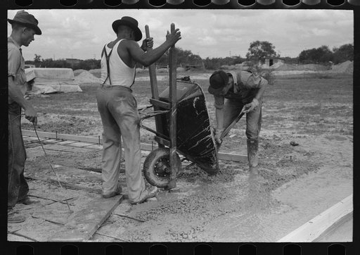 Pouring concrete at migrant camp under construction at Sinton, Texas
