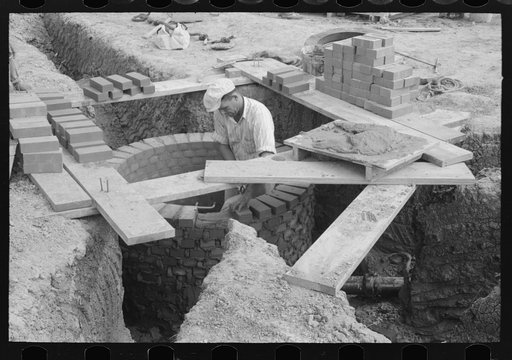 Untitled photo, possibly related to: Laying bricks in construction of manhole at migrant camp at Sinton, Texas