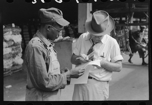 Trucker and weighing checker at unloading platform. Cotton compress, Houston, Texas