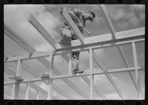Carpenter working on a framework of a unit of the migrant camp at Sinton, Texas