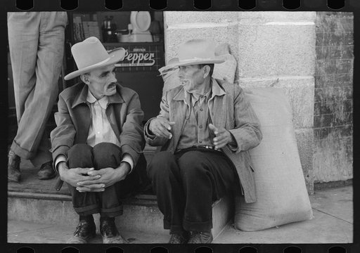 Mexican farmers talking in town, Taylor, Texas