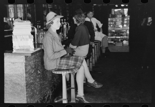 Woman sitting at soda fountain, Taylor, Texas