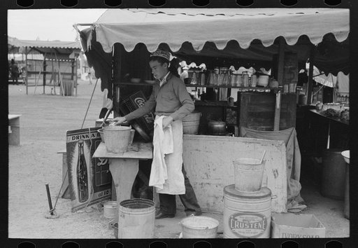 Dishwasher at hamburger stand, county fair, Gonzales, Texas