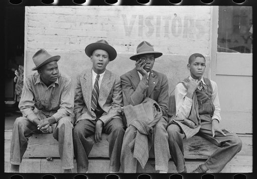 Negro boys sitting on bench on street, Waco, Texas