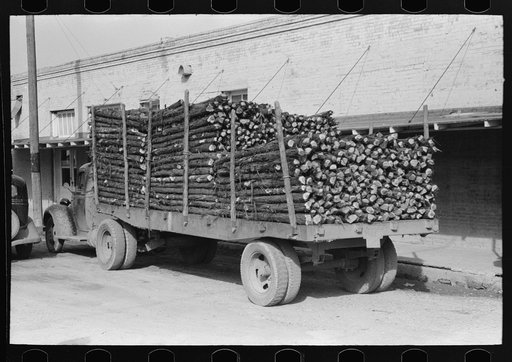 Truckloads of fence posts en route for Oklahoma. Clifton, Texas