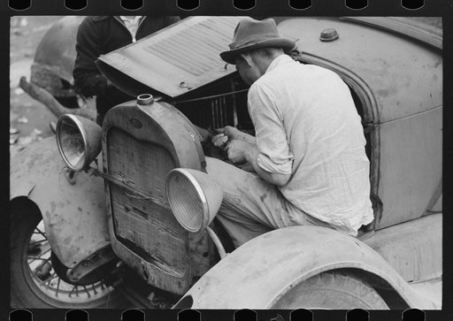 Untitled photo, possibly related to: Repairing an automobile motor, market square, Waco, Texas