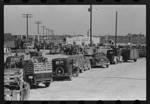Untitled photo, possibly related to: Lineup of trucks waiting to be unloaded at stockyard, San Angelo, Texas