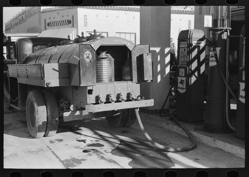 Untitled photo, possibly related to: Gasoline truck driver getting ready to fill service stations tank with gasoline, San Angelo, Texas