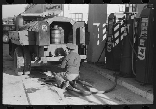 Gasoline truck driver getting ready to fill service stations tank with gasoline, San Angelo, Texas