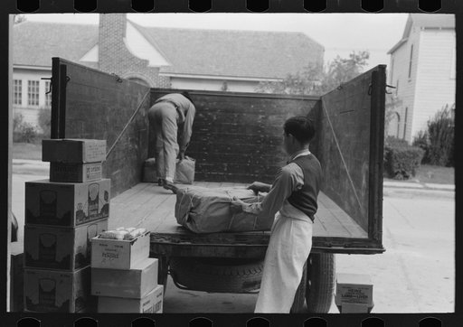 Unloading wholesale grocery truck at retail store, San Angelo, Texas