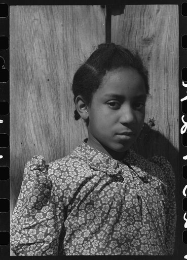 Untitled photo, possibly related to: Daughter of Pomp Hall, Negro tenant farmer, feeding corn to her three chickens which were her 4-H Club project, Creek County, Oklahoma. See general caption number 23