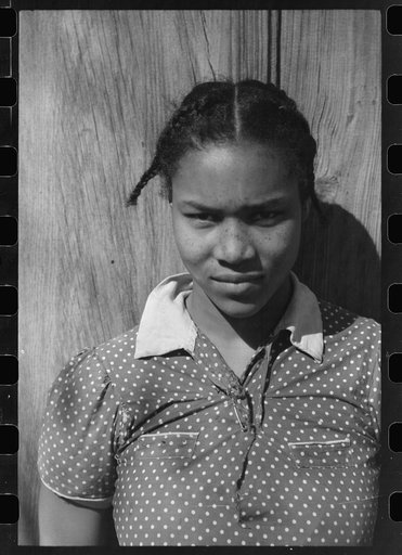 Untitled photo, possibly related to: Oldest daughter of Pomp Hall, tenant farmer, with an ear of corn which she is shelling to feed her chickens, Creek County, Oklahoma. See general caption number 23